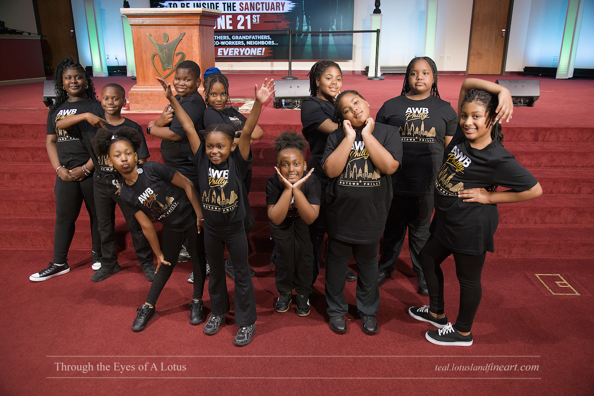 Young performers in AWB Philly T-shirts posing on stage at the Arts Without Boundaries 2026 Showcase